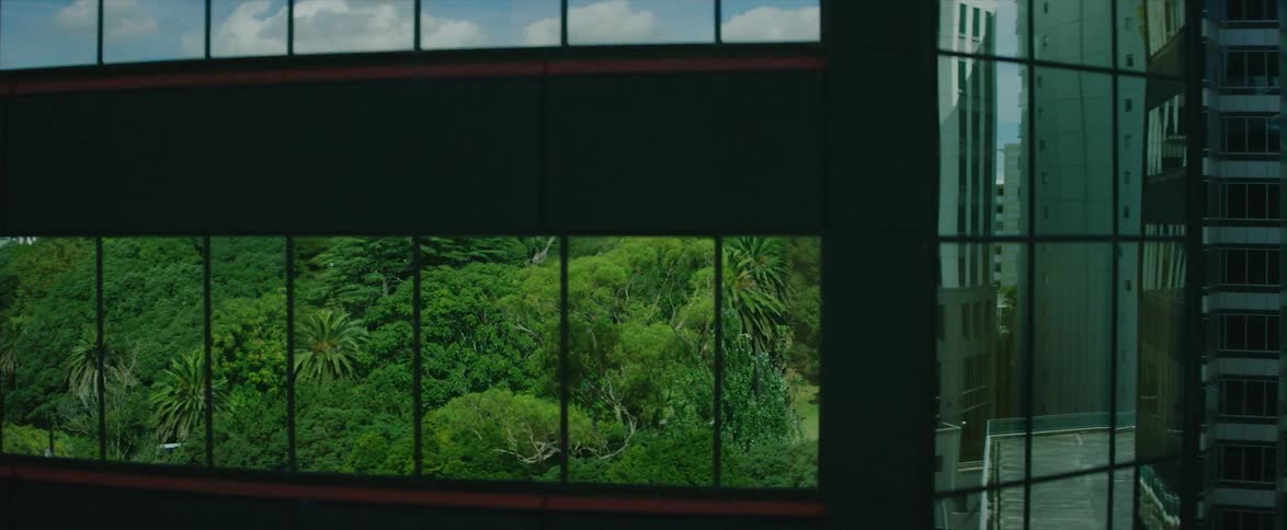 Buildings reflected in windows of a large building