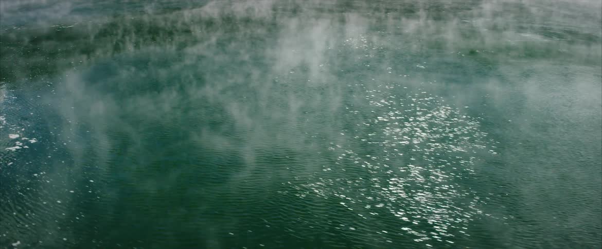 Steam pours from a hot spring