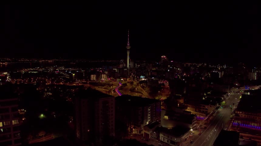 City buildings illuminate the night sky