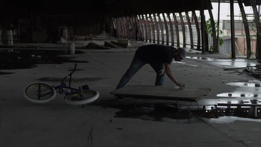 A man is spray painting something on the ground