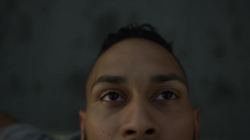 A man riding on something stares upwards