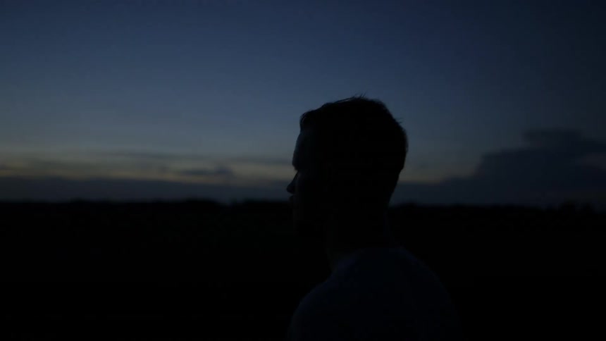Man walks outside at sunset