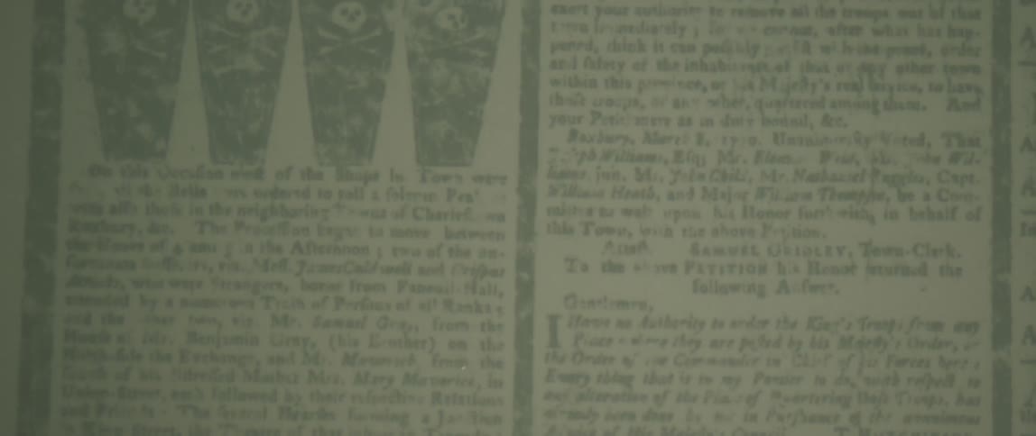 Newspaper articles are shown on the screen of a microfiche machine