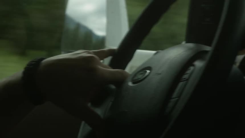 A person is driving their car down the road