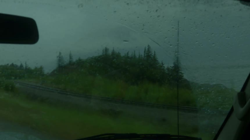 Windshield wipers swipe the rain on  the windshield