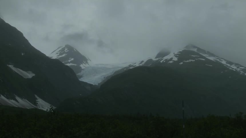 The clouds roll over the mountains on a very cloudy day