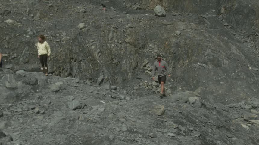 A woman hiking with friends takes a photo and socializes