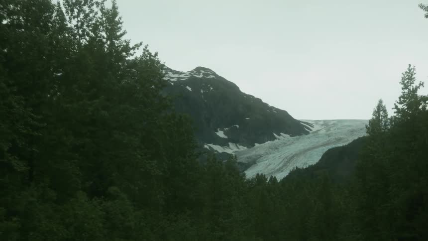A vehicle drives on a mountain road