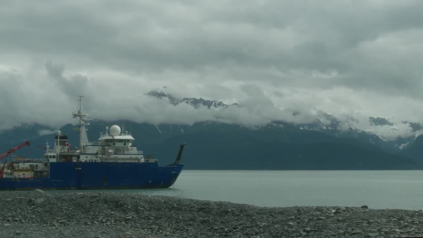 Large ship parked near the shore of a lake