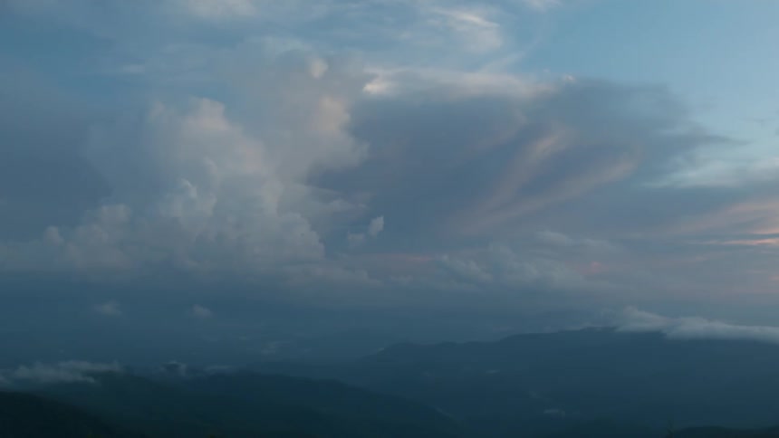 Clouds hang above a valley