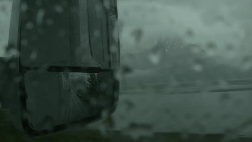 Side mirror of a vehicle on a rainy day