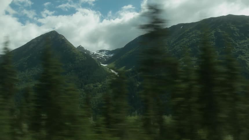 Clouds hang above mountains