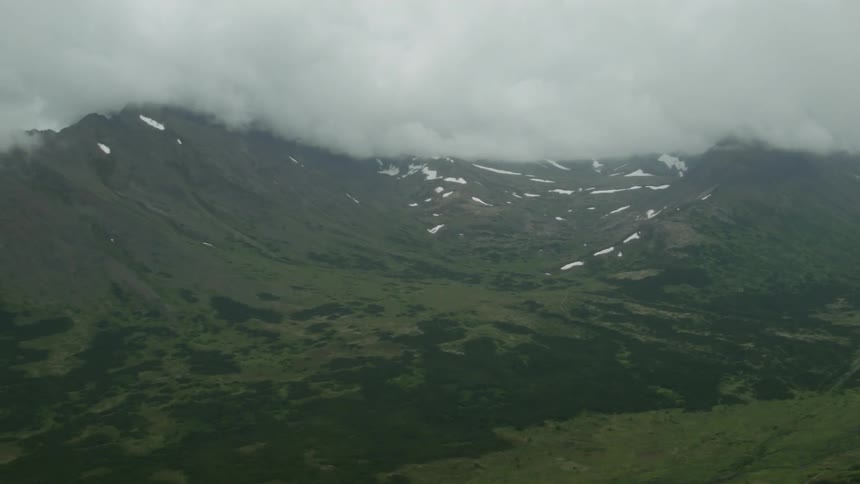 Clouds cover the mountain peaks