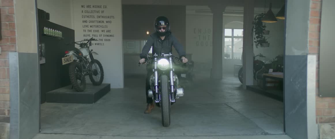 A motorcyclist pulls out of a garage