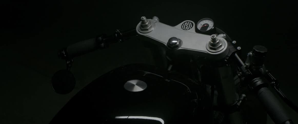 The light flashes over the motorcycle in the dark