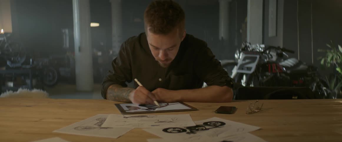 Man draws a sketch with a pencil