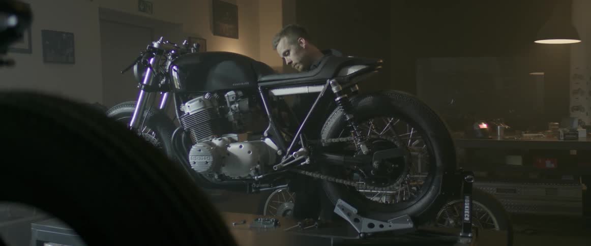 Man works on a motorcycle in a garage