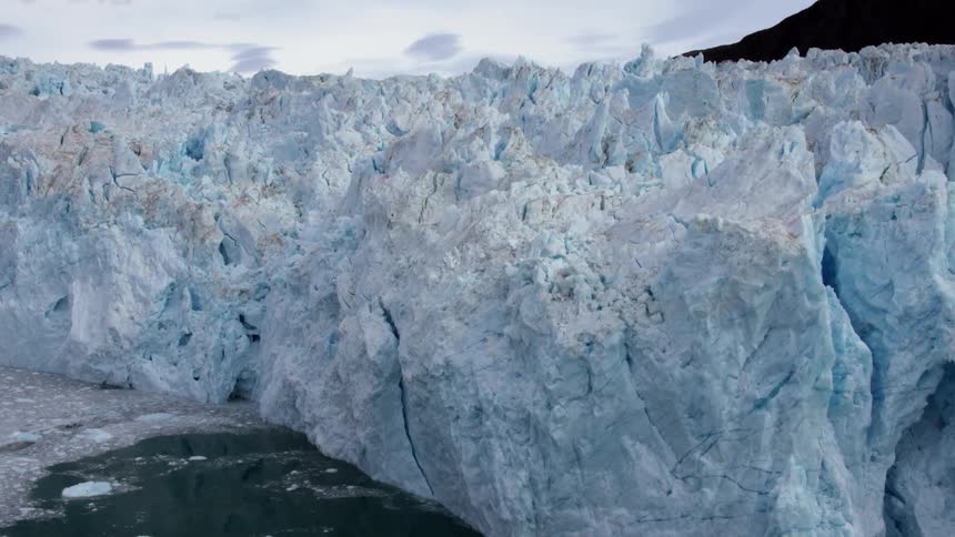 The ice is blue and slowly melting near this shore