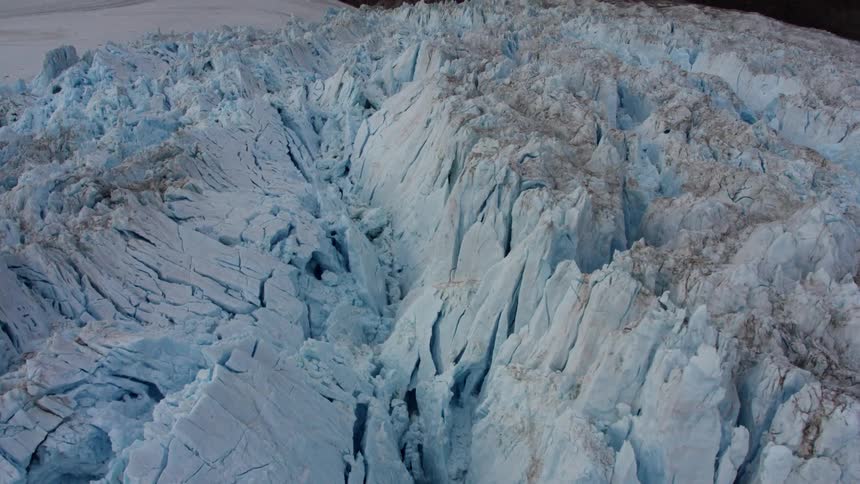 A large iceberg is filmed from a drone
