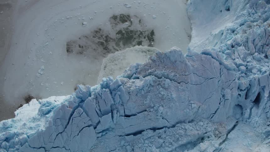 A huge ice wall is melting into the water below