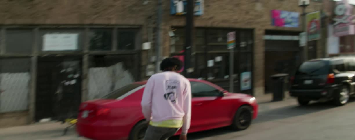 A man is riding a skateboard down an empty street