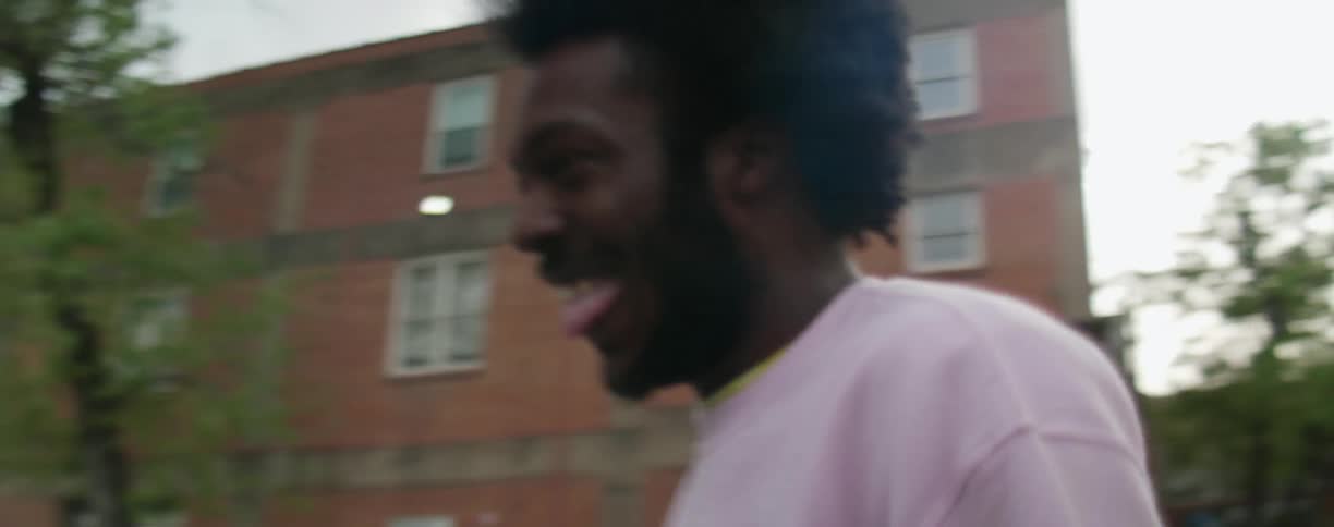 A man is talking and laughing by the road