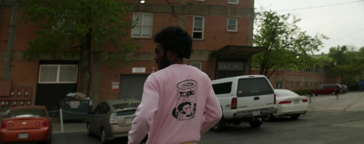 A man is walking across the parking lot