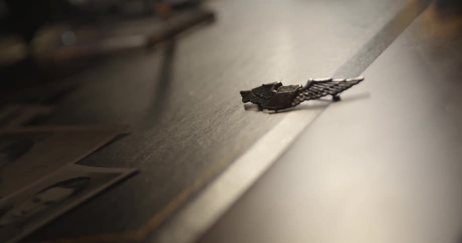 A small metal object sits on a surface