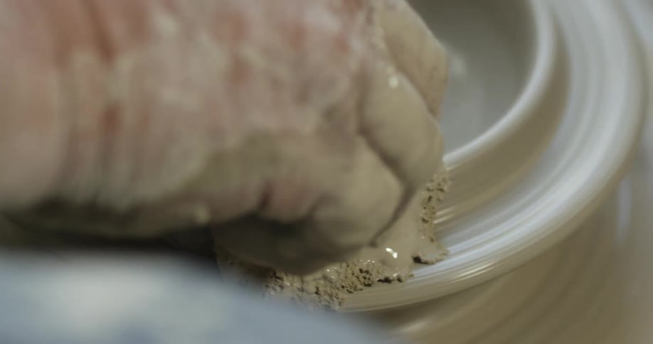 Hands work with ceramic clay