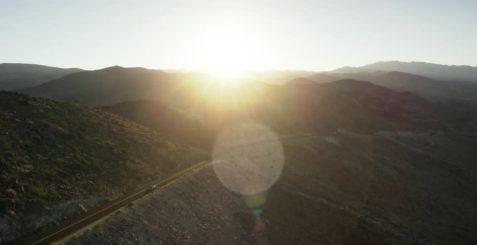 The sun is setting behind the mountains