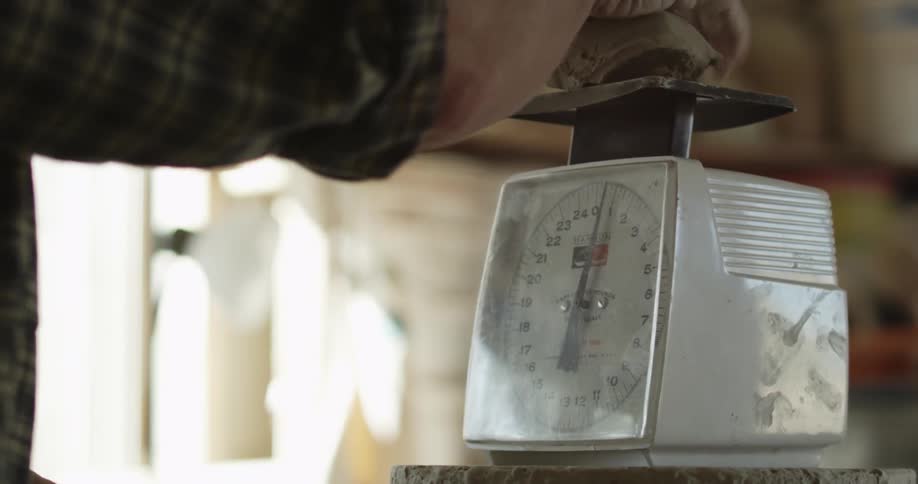 A woman is preparing to weigh something