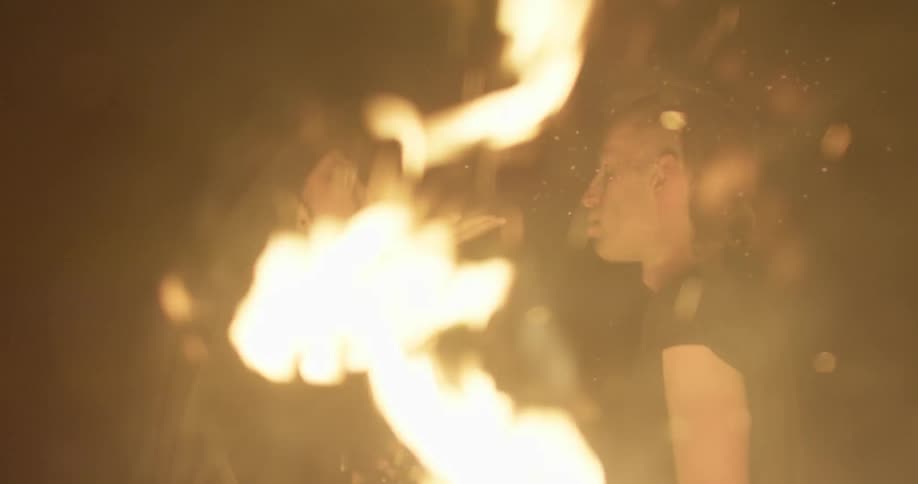 A woman is talking with a man by a fire