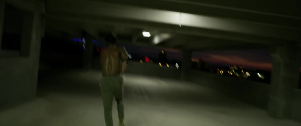 Man sprints through an empty parking garage