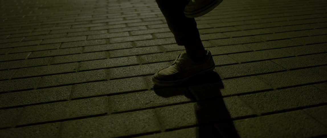 Man dances on a brick ground