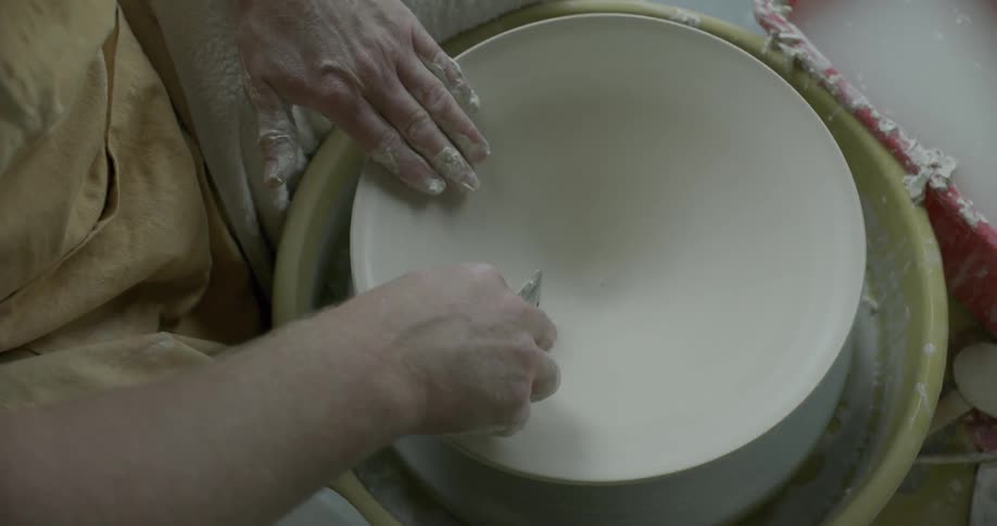 Pottery maker creates a pottery bowl