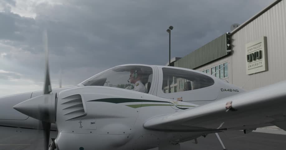 A man is starting up a small plane