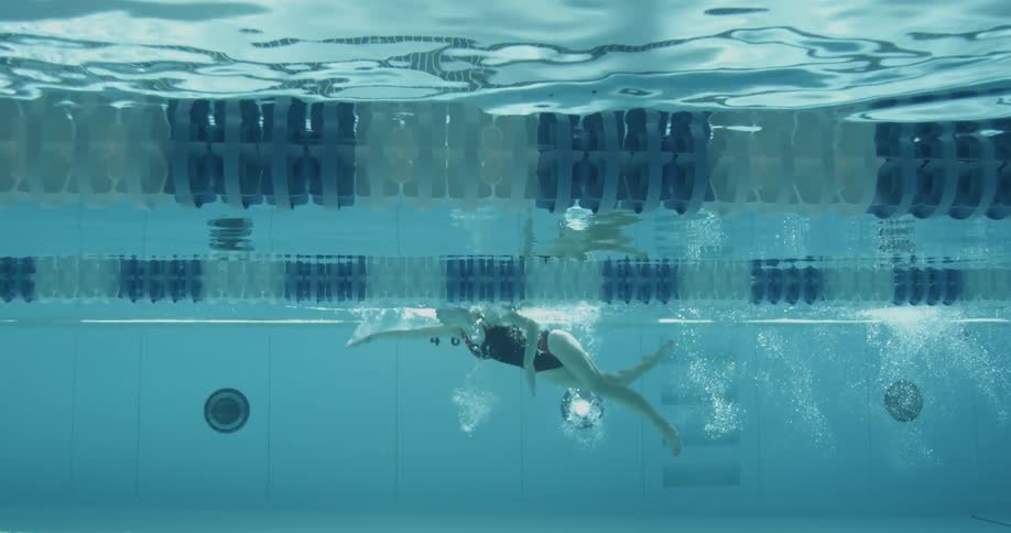 Woman swims in a public pool