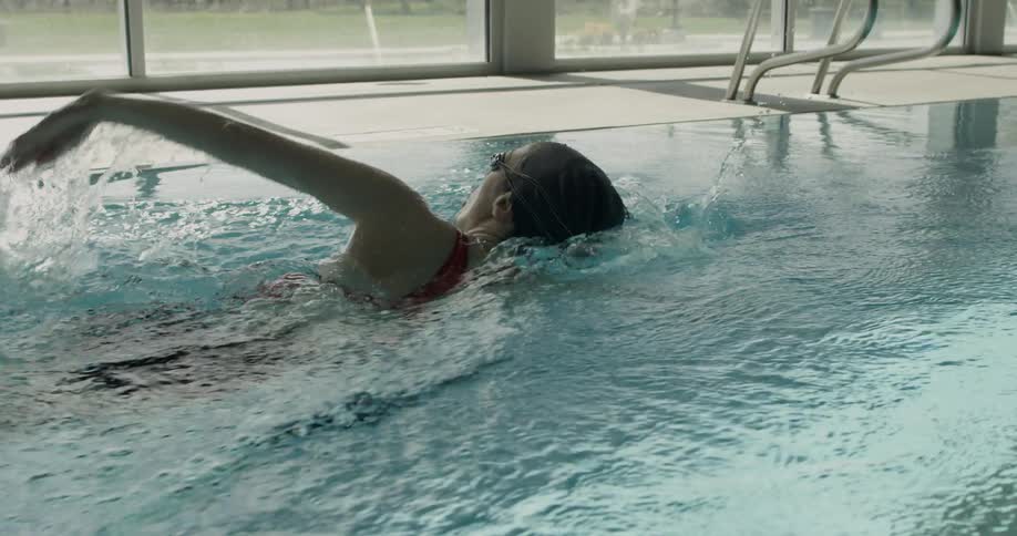 Woman swims in indoor pool