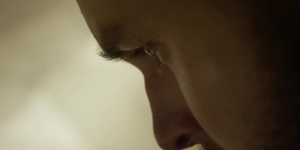 A man stares intently downward