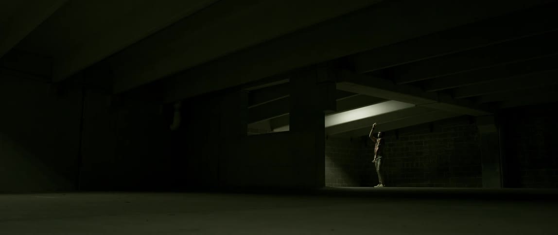 Man dances in a dark building