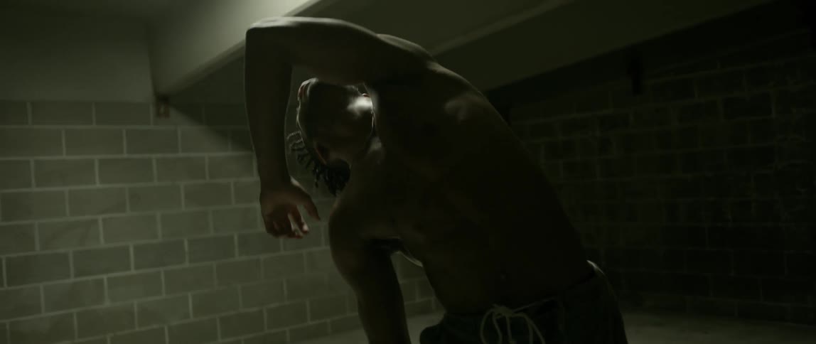 A man dances in a brick room