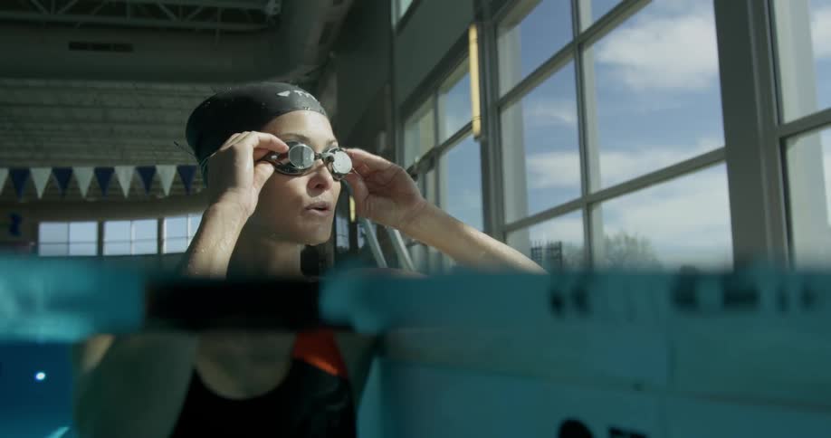 A woman in goggles is swimming