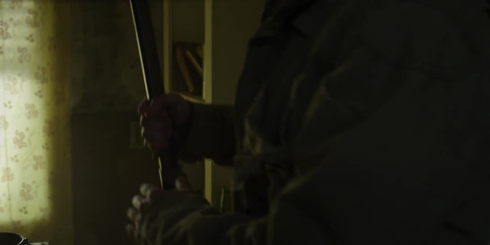 A person picks up a gun