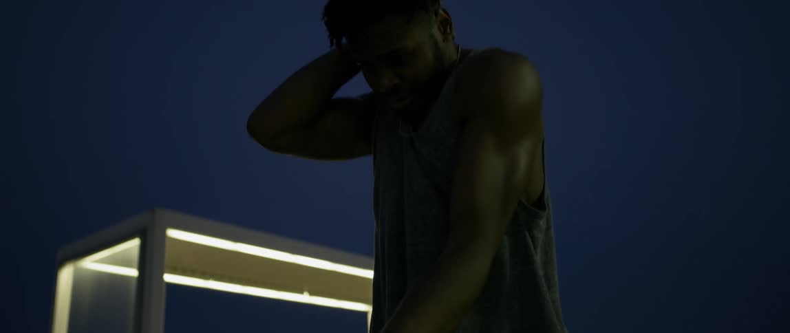 Man dances outside at night