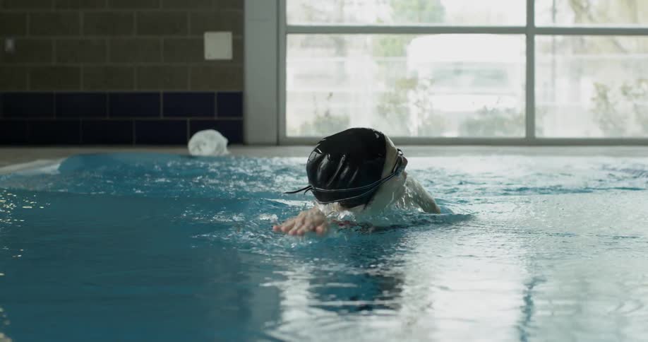 Woman swims in an indoor pool
