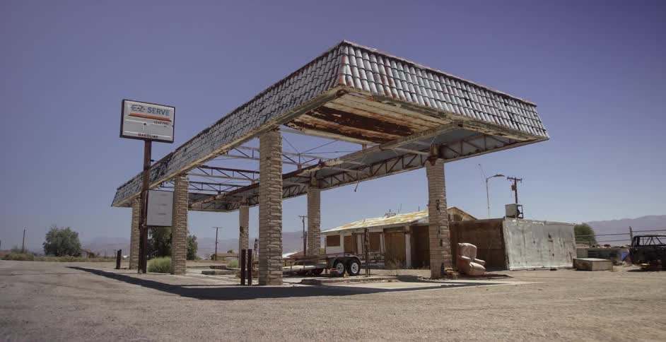 An abandoned gas station on the side of the highway