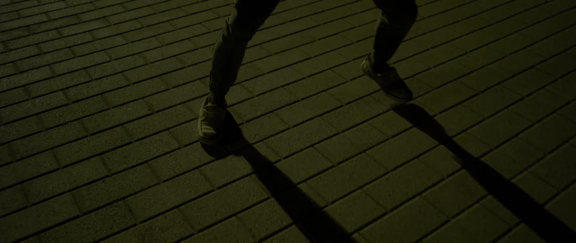 A man is walking on the roof at night