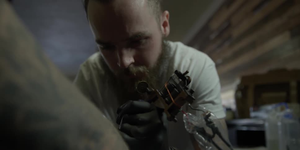A person tattoos another person