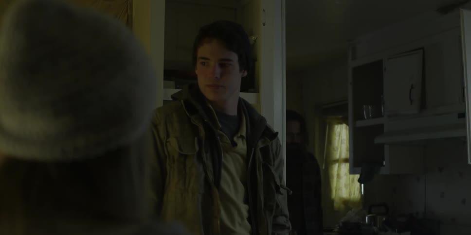 Boy watches as a man walks by in the house