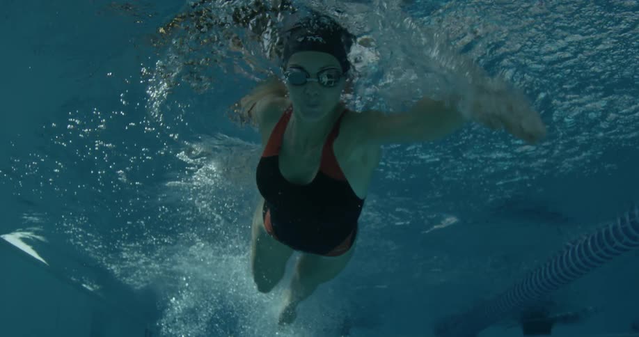Person swims underwater in a pool